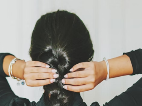 Hands braiding hair